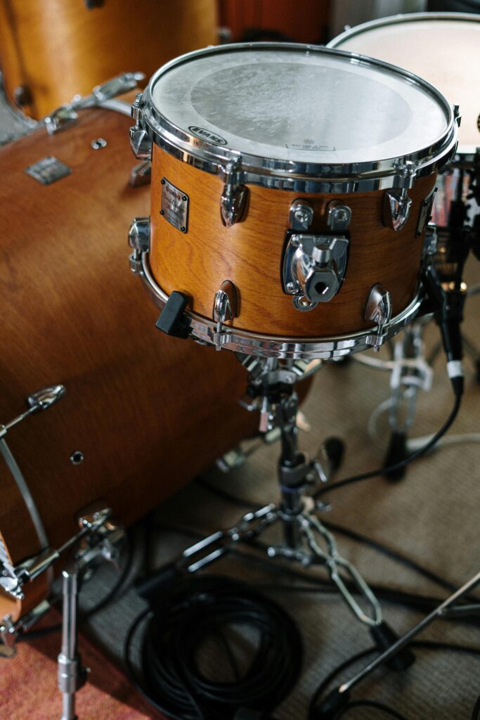Close-up of a wooden drum set in a music studio, capturing musical detail.